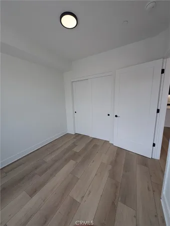 an empty room with wooden floor