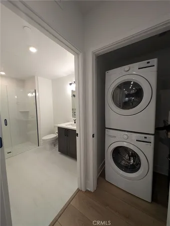 a view of a hallway with washer and dryer