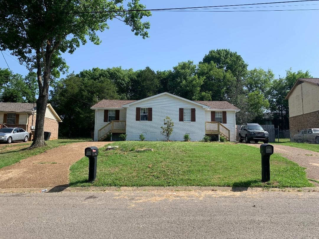 709 Eric Drive Nashville, TN 37207 - Photo 2 of 28 a front view of a house with a garden and trees