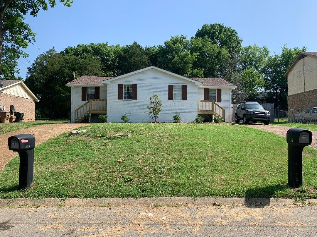 709 Eric Drive Nashville, TN 37207 - Photo 3 of 28 a front view of a house with a yard and trees