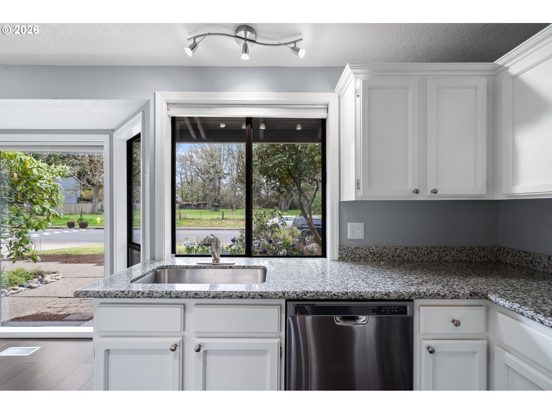 895 Southwest 166th Avenue Beaverton, OR 97006 - Photo 11 of 36 a kitchen with granite countertop a sink and a window