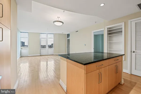 a kitchen with granite countertop a sink and cabinets