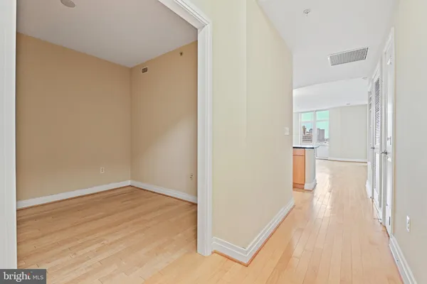 a view of a hallway with wooden floor