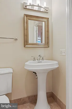 a bathroom with a sink a toilet and mirror