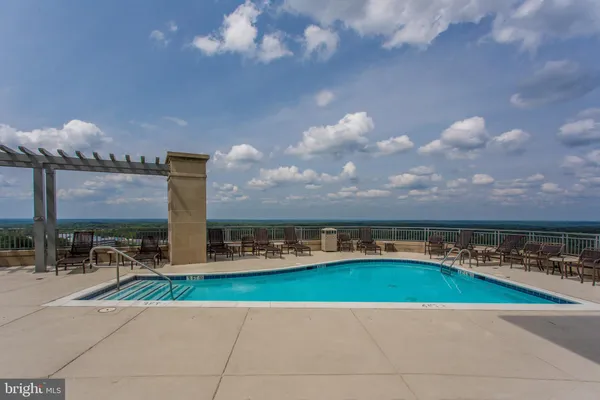 a view of a swimming pool with outdoor seating