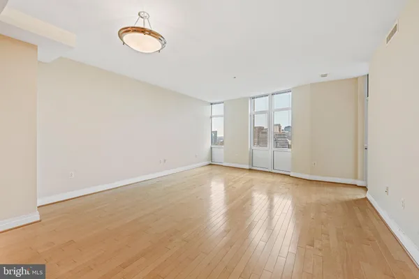a view of empty room with wooden floor