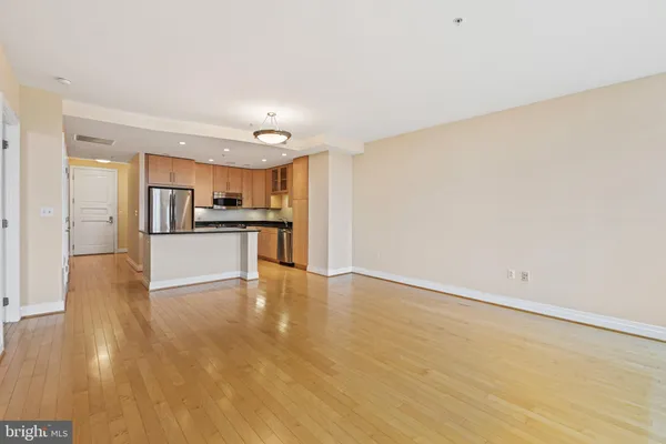 a view of a kitchen with a sink and a refrigerator