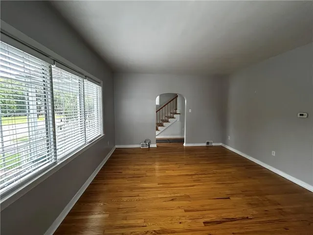 a view of a room with wooden floor and a window