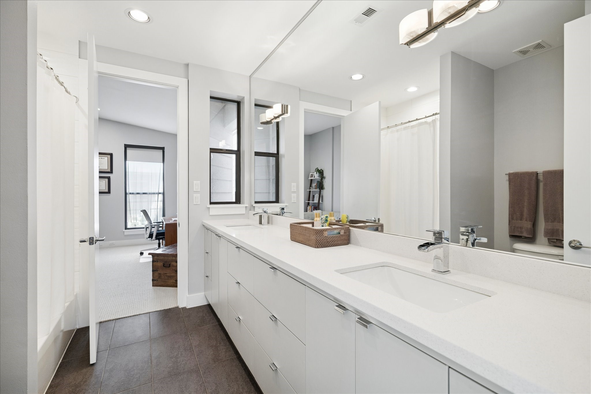 6504 Rodrigo Street, Unit B Houston, TX 77007 - Photo 19 of 29 A long double vanity, quartz countertops, and white cabinetry — the Jack-and-Jill bath done right.