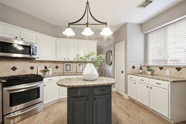 a kitchen with a sink stove and microwave