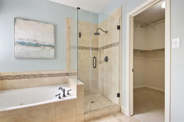 a bathroom with a bathtub and a shower