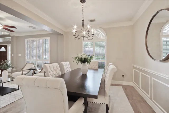 a view of a dining room with furniture and a chandelier