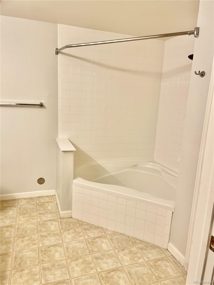 5800 Tower Road, Unit 102 Denver, CO 80249 - Photo 7 of 14 a bathroom with a shower and a shower