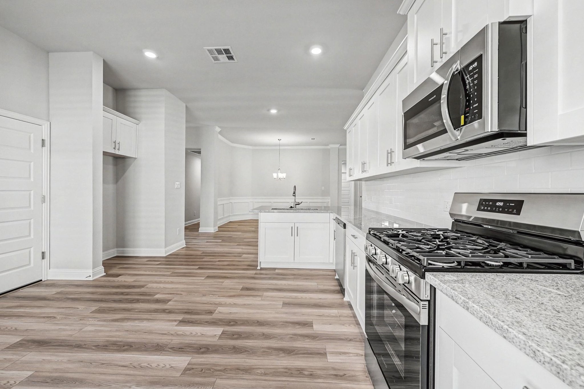 601 Greystone Lane Angleton, TX 77515 - Photo 13 of 32 a kitchen with stainless steel appliances granite countertop a stove and a refrigerator