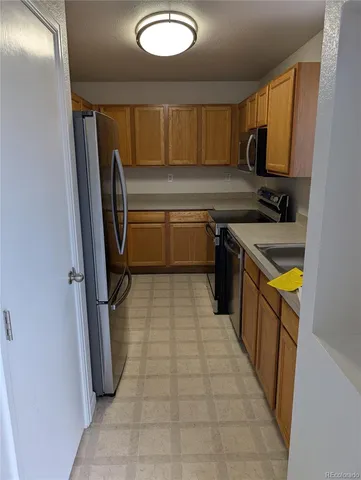a bathroom with a granite countertop shower and a sink