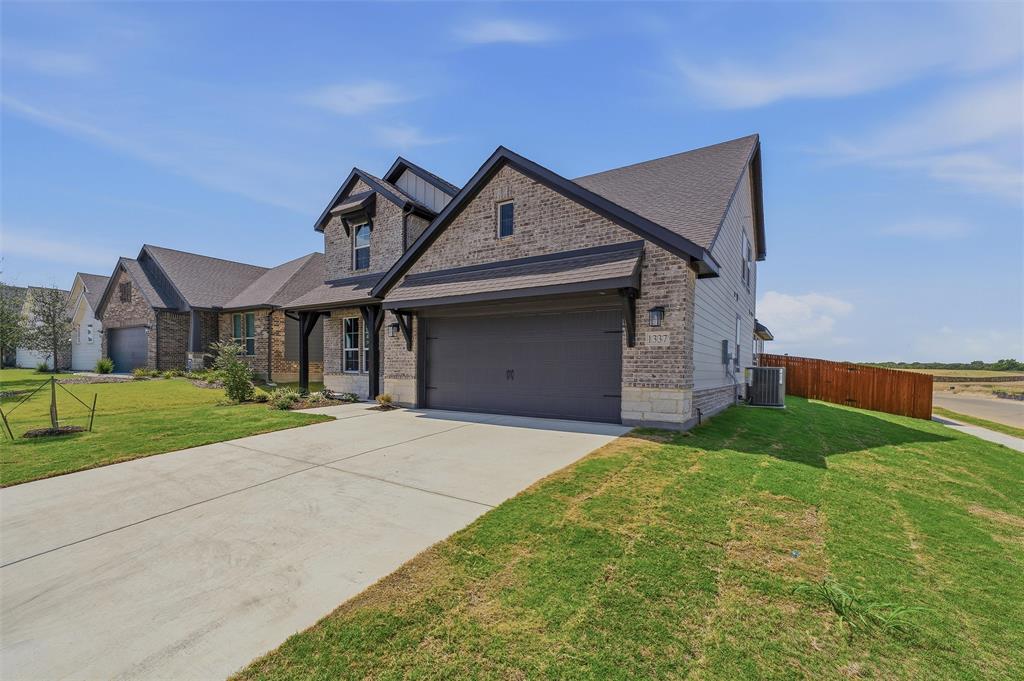 1337 Frio Drive Springtown, TX 76082 - Photo 3 of 40 Two-story residence featuring a brick and siding exterior, a two-car garage, and a concrete driveway