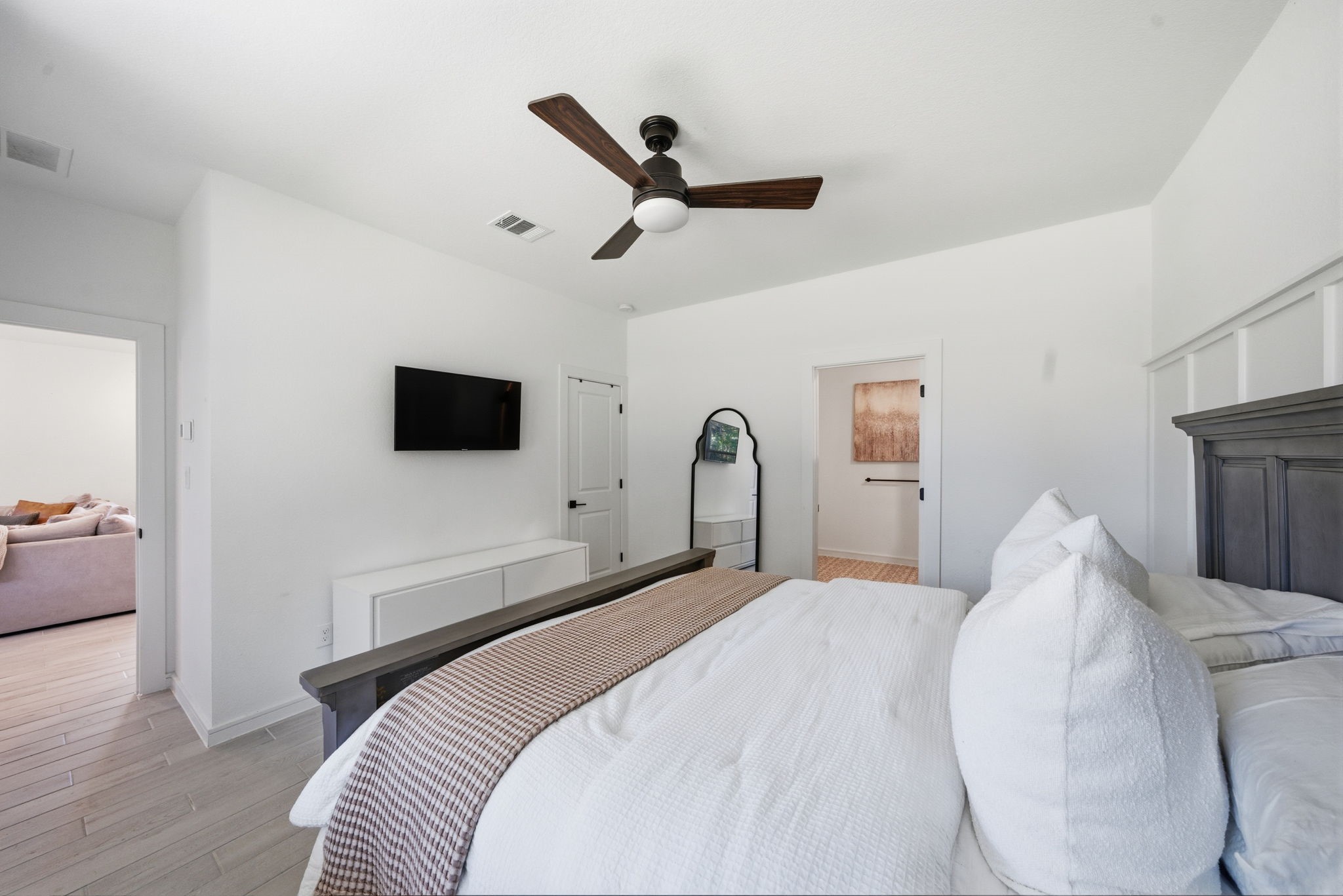 302 Alder Loop Anahuac, TX 77514 - Photo 20 of 34 This bedroom features a modern design with and a ceiling fan. Natural light streams in making this primary bedroom bright and inviting, perfect for relaxation.