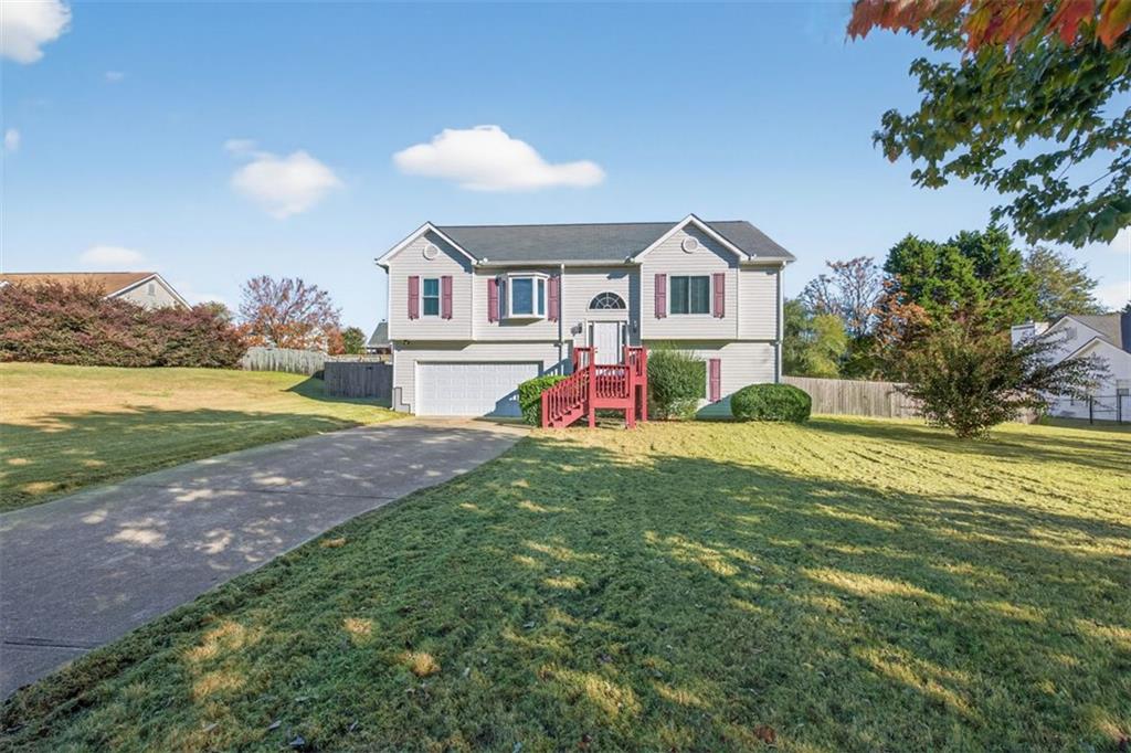 303 Ron Drive Bethlehem, GA 30620 - Photo 1 of 1 a front view of house with yard and trees in the background
