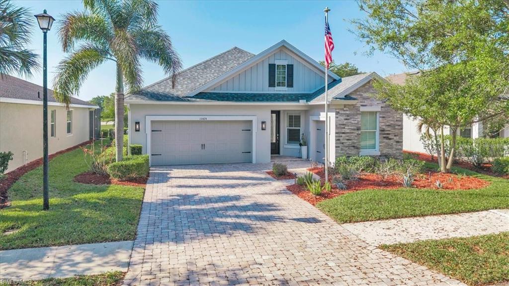 16424 Windsor Way Alva, FL 33920 - Photo 2 of 48 a front view of a house with a yard and potted plants