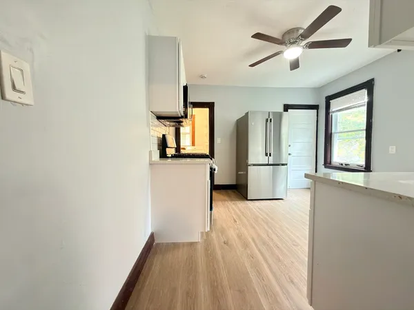 a view of a kitchen with a sink and a window