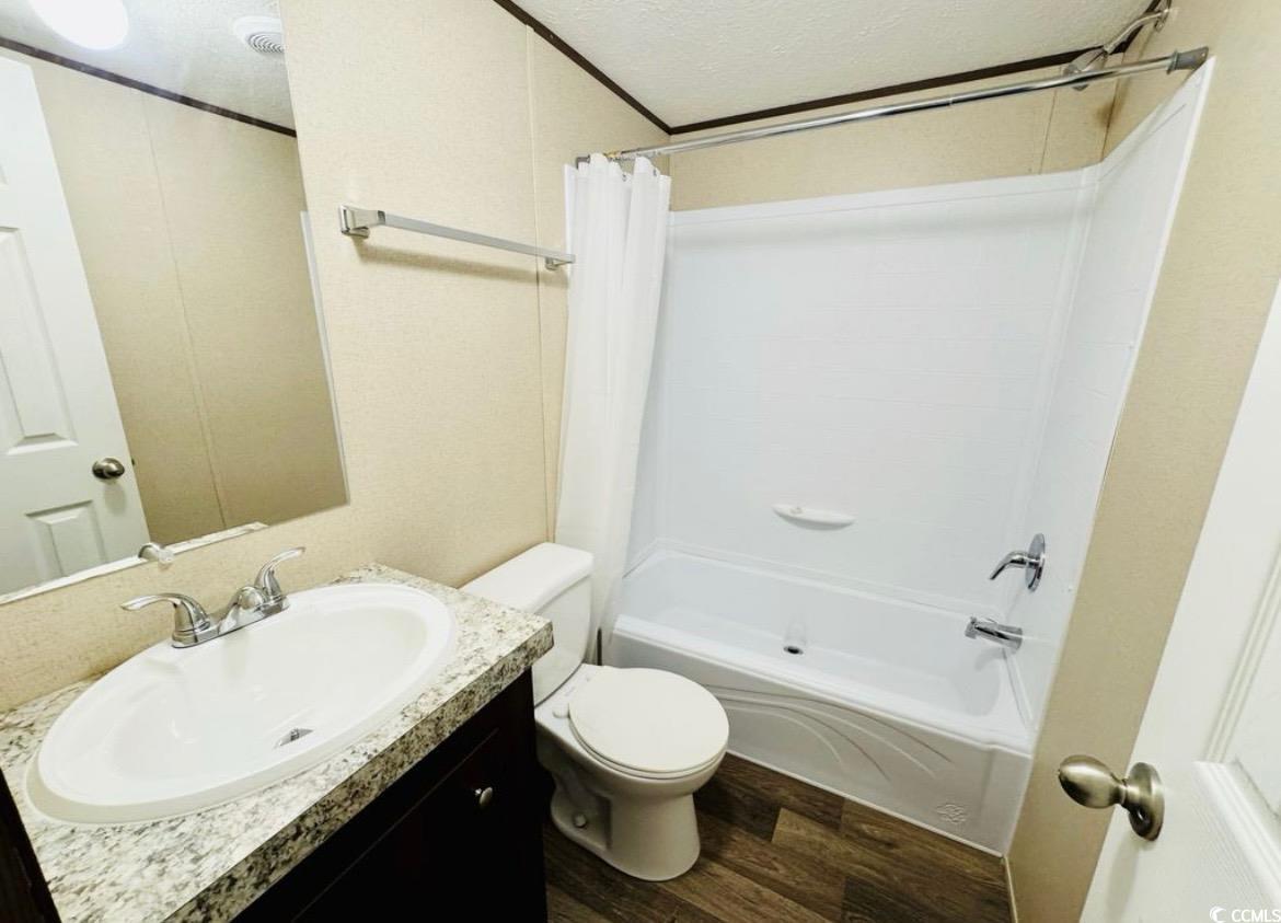 2433 Old Corner Court Marion, SC 29571 - Photo 12 of 18 Bathroom with shower / tub combo, a textured ceiling, wood finished floors, and vanity