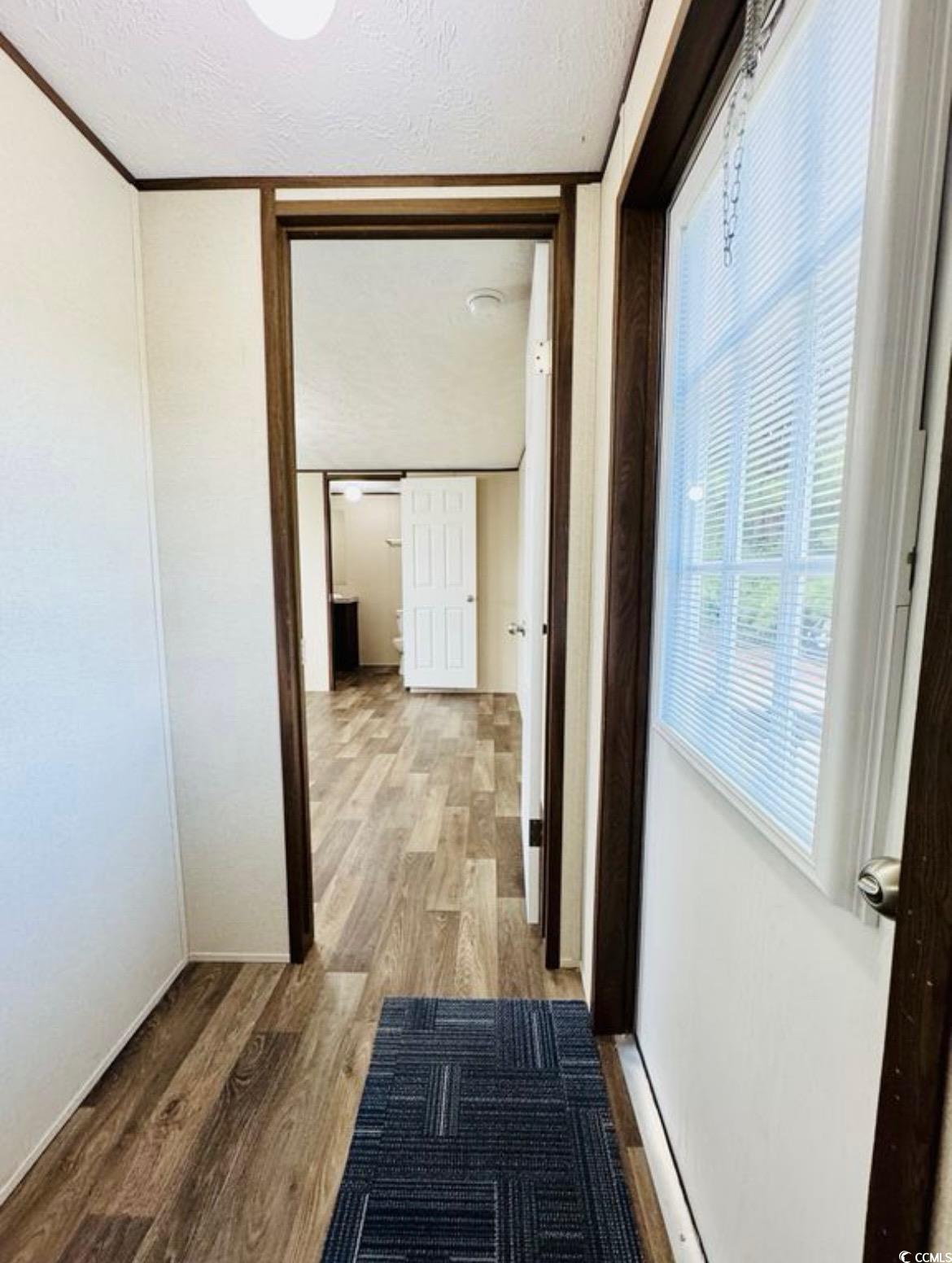 2433 Old Corner Court Marion, SC 29571 - Photo 14 of 18 Corridor with wood finished floors and a textured ceiling