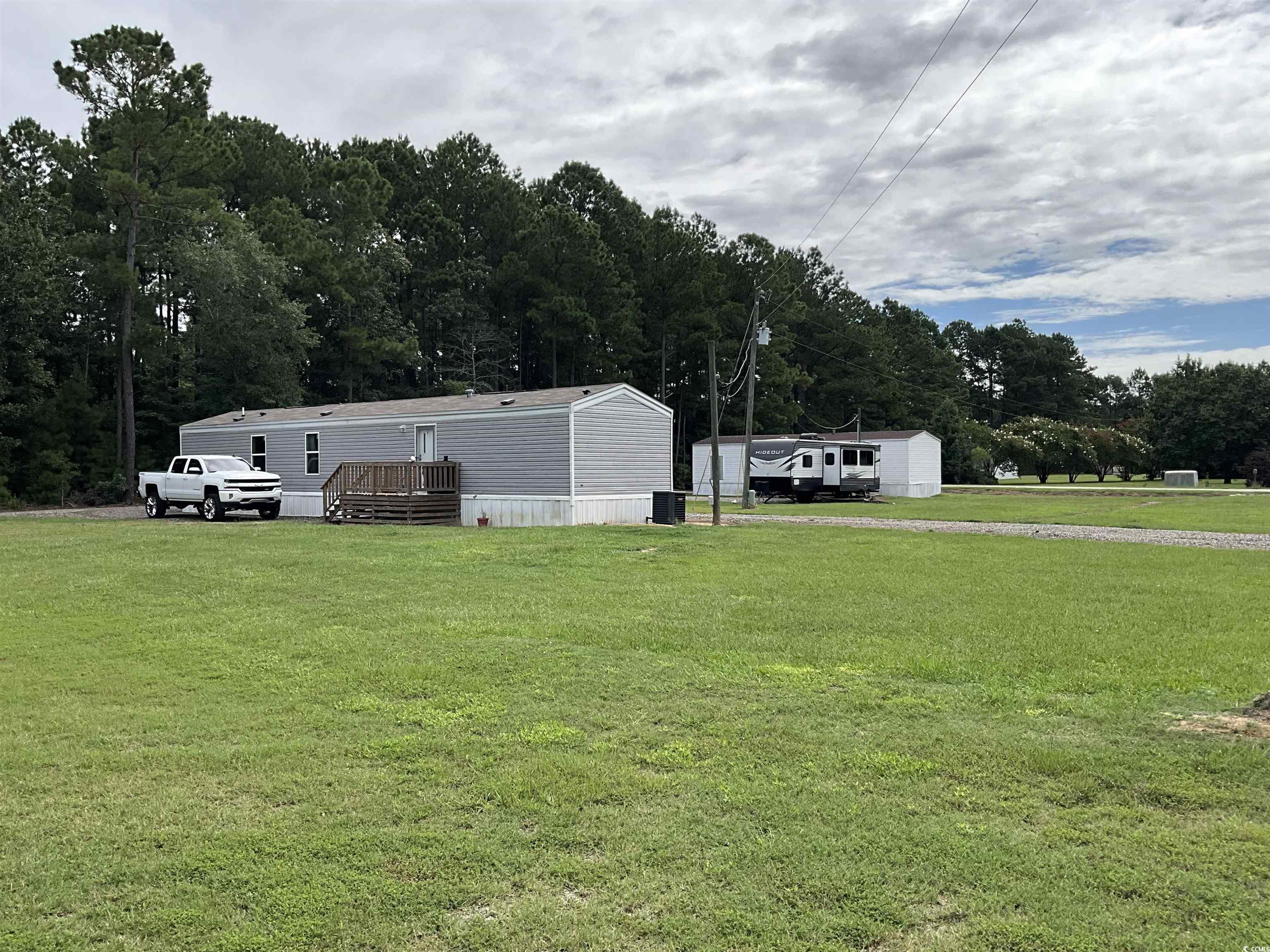 2433 Old Corner Court Marion, SC 29571 - Photo 5 of 18 View of green lawn featuring a wooden deck