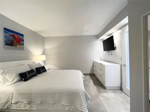 a bedroom with a bed and a television