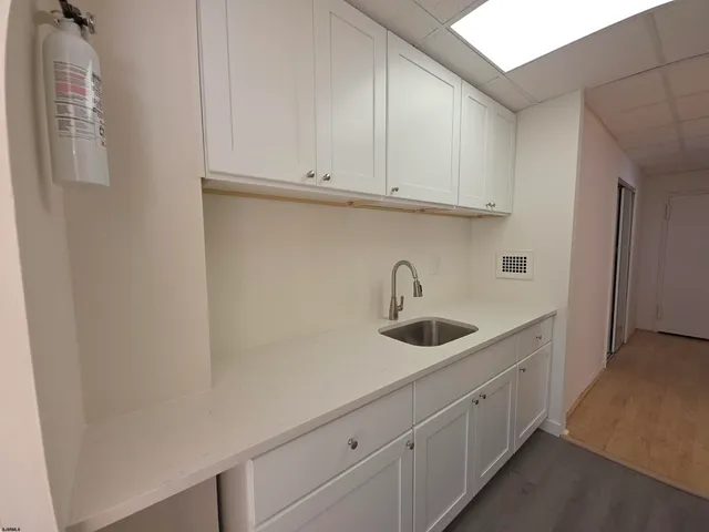 a kitchen with stainless steel appliances granite countertop white cabinets and sink