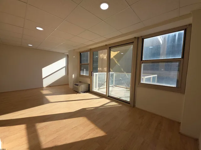 a spacious bedroom with a large bed and a large window