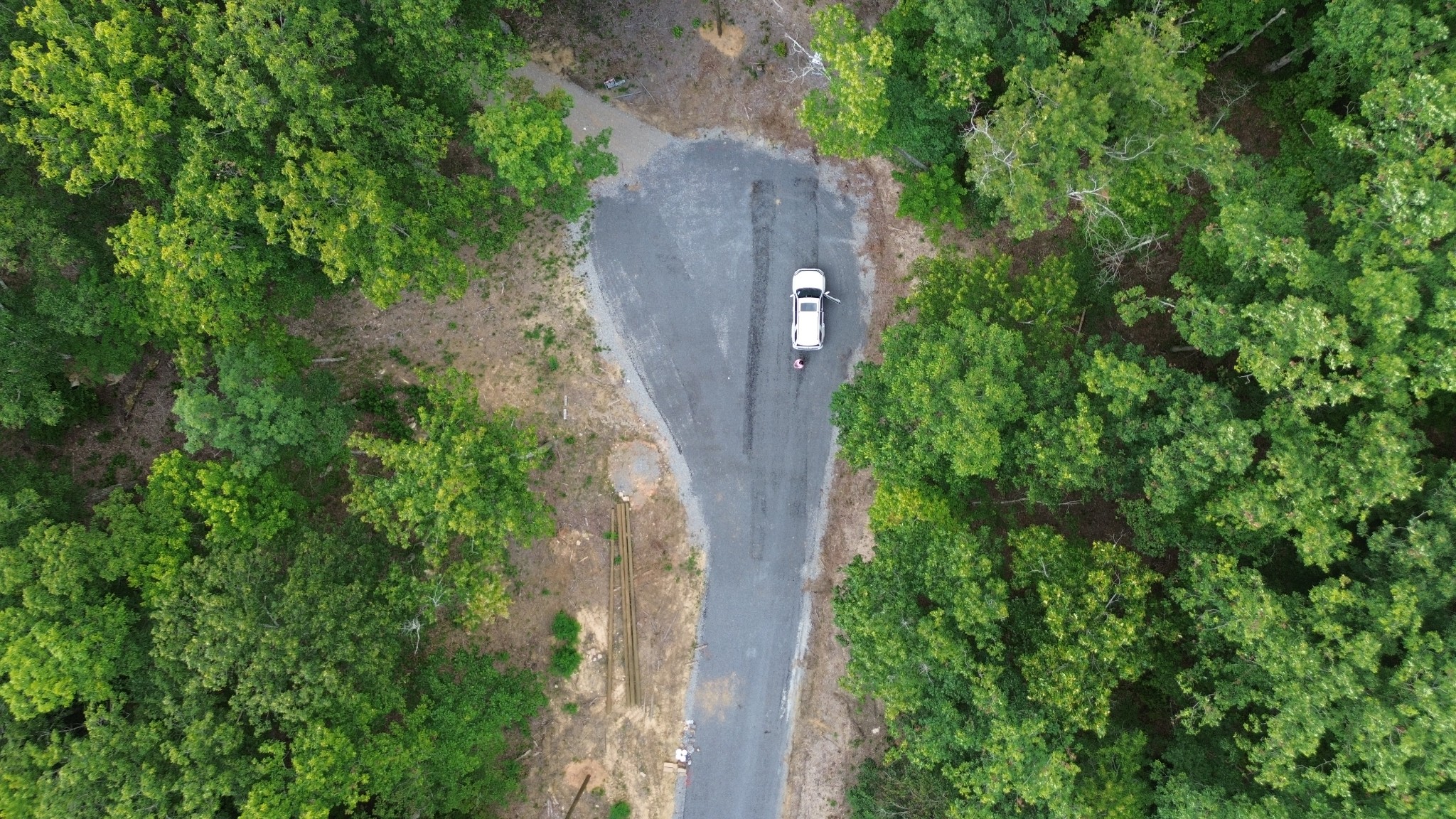 an aerial view of a house with a yard and a large tree