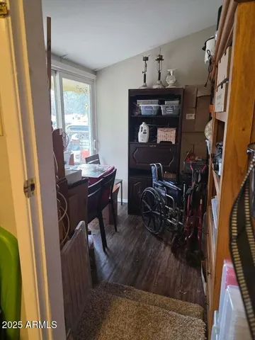 a view of a workspace with furniture and a window