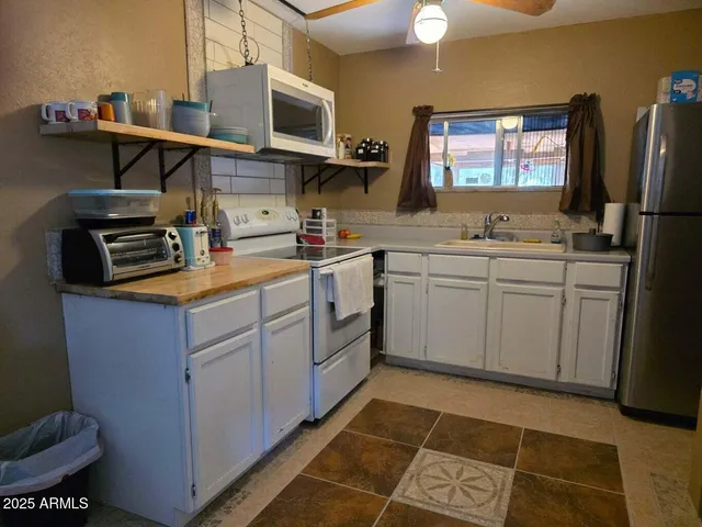 a kitchen with a sink cabinets and appliances