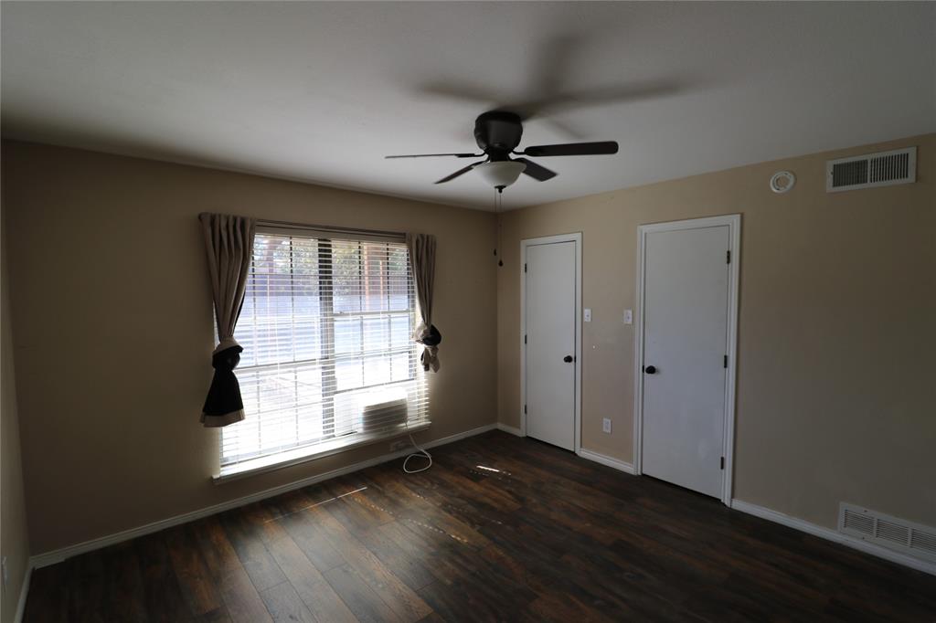 200 Red Oak Creek Road Oak Leaf, TX 75154 - Photo 10 of 11 a view of an empty room with wooden floor and a window