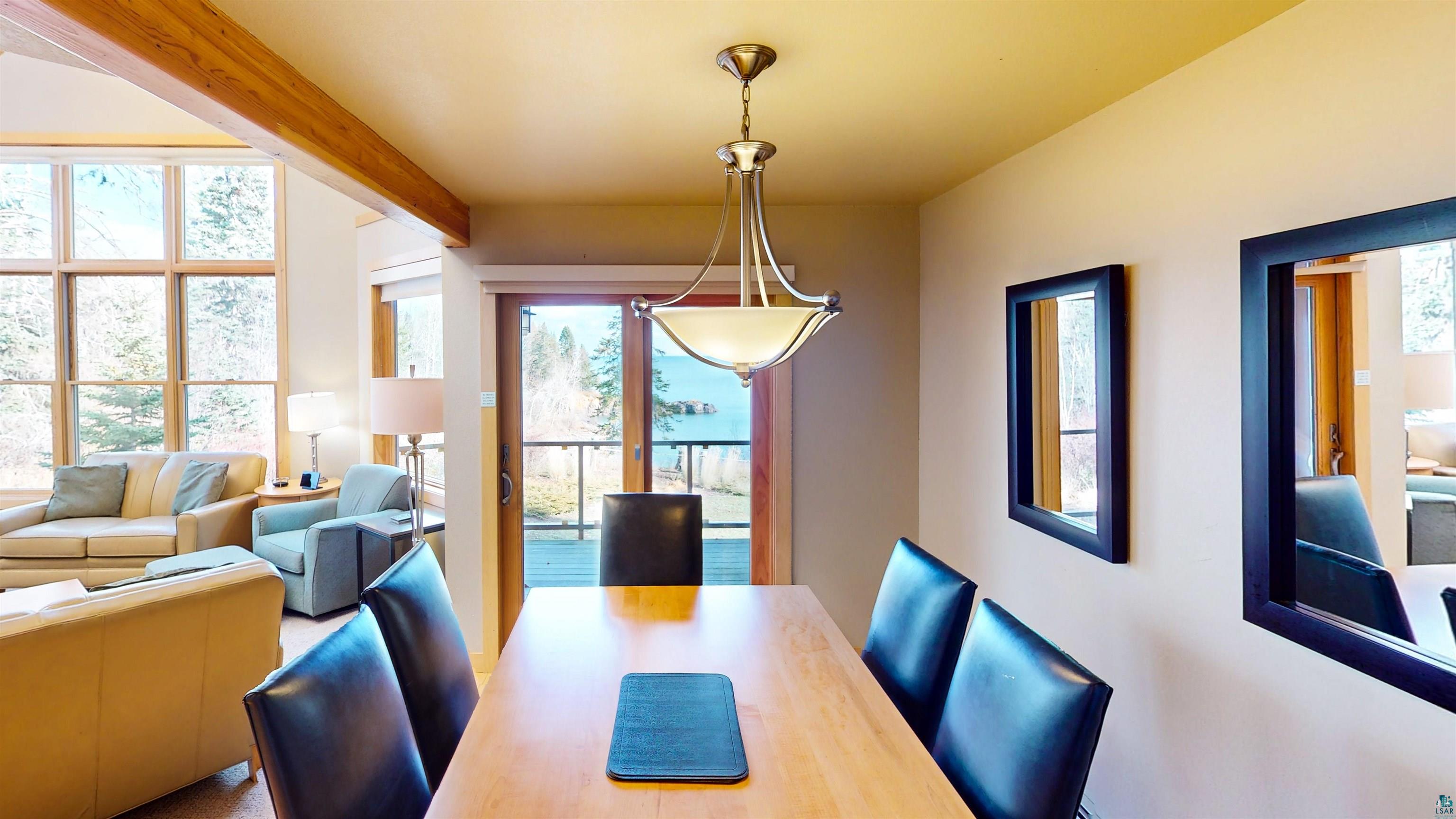 40 Surfside Drive, Unit 5D Tofte, MN 55615 - Photo 30 of 37 Dining area with a light wood-finish table and dark leather-look chairs