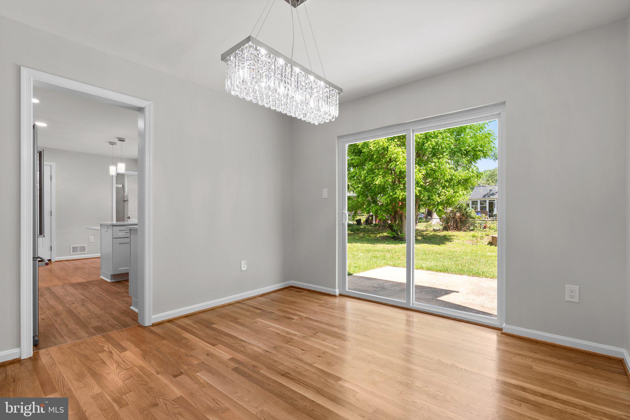 5525 Rolling Road Springfield, VA 22151 - Photo 51 of 89 a view of an empty room with wooden floor and a window