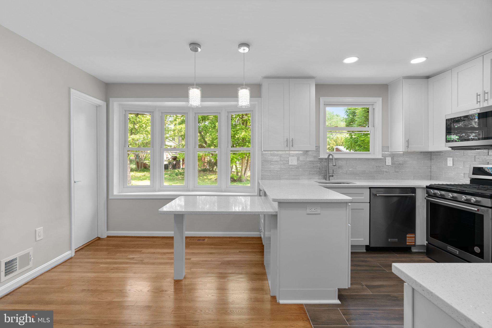 5525 Rolling Road Springfield, VA 22151 - Photo 56 of 89 a kitchen with stainless steel appliances granite countertop a stove a sink and a microwave