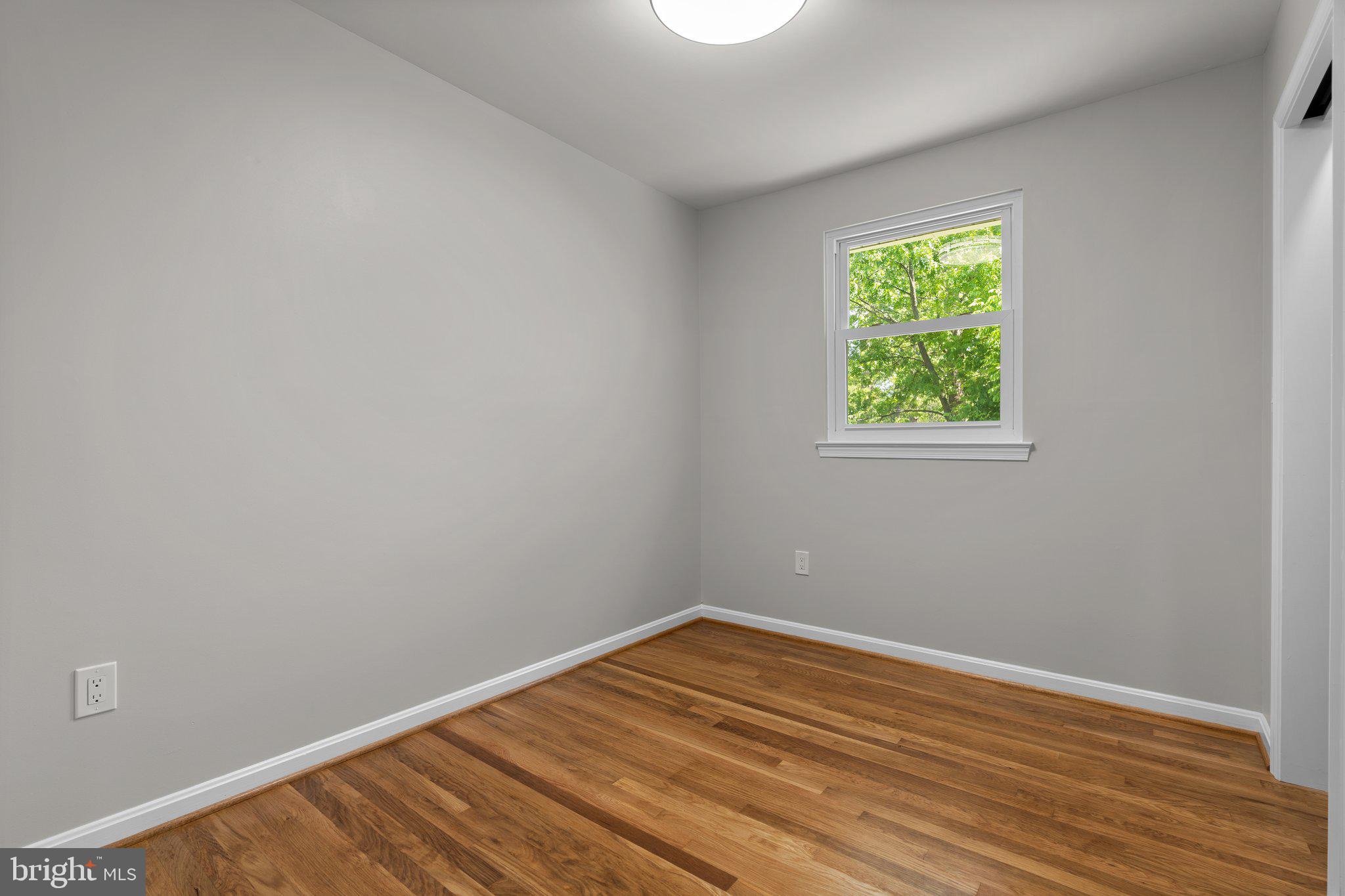 5525 Rolling Road Springfield, VA 22151 - Photo 64 of 89 a view of an empty room with wooden floor and a window