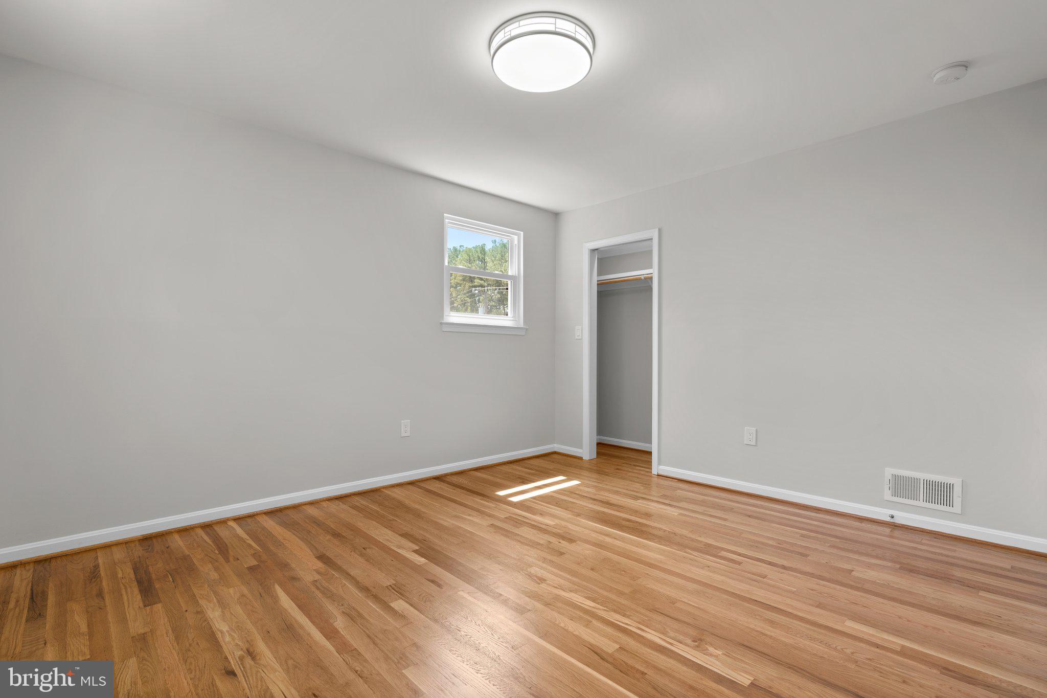 5525 Rolling Road Springfield, VA 22151 - Photo 72 of 89 an empty room with wooden floor and windows