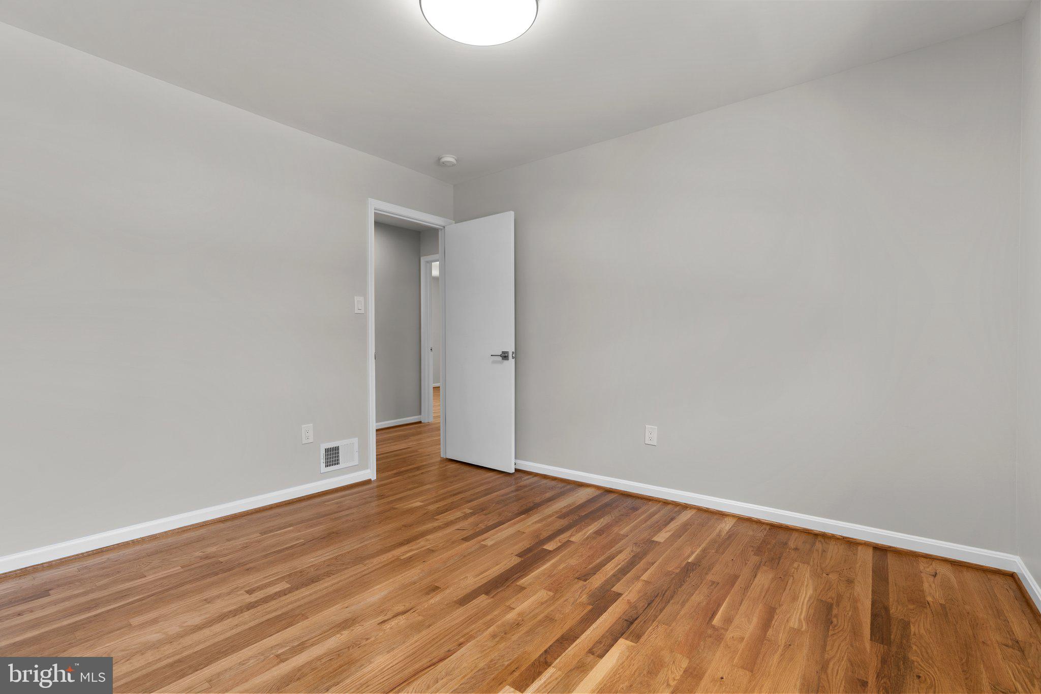 5525 Rolling Road Springfield, VA 22151 - Photo 80 of 89 a view of an empty room with wooden floor