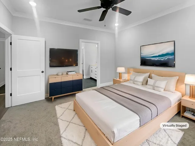 a bedroom with a bed and a flat screen tv