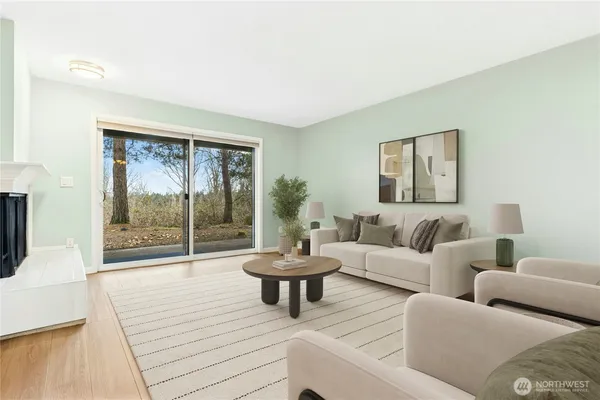 a living room with couches a coffee table and a large window with outer view
