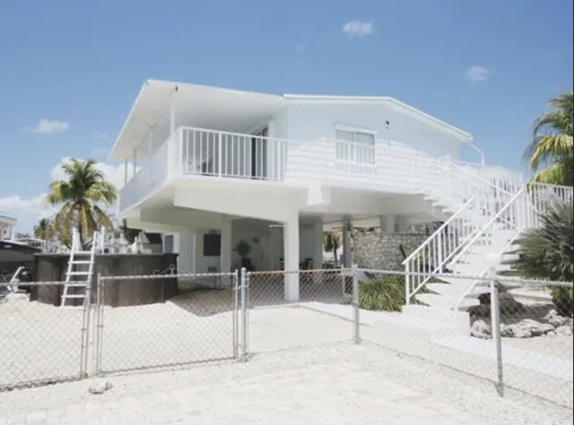 a view of a house with a wooden fence