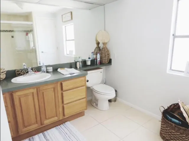 a bathroom with a sink a toilet and a mirror