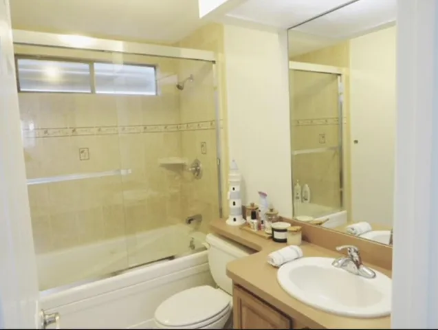 a bathroom with a sink toilet tub and shower