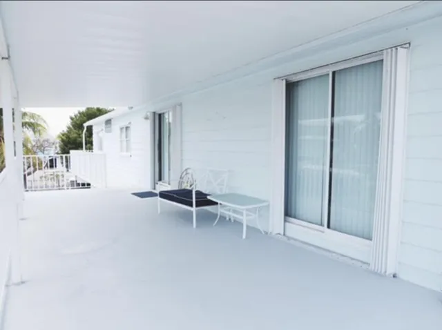 an empty room with windows and bench