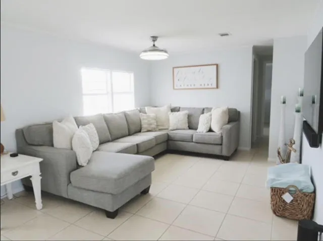 a living room with furniture and a large window