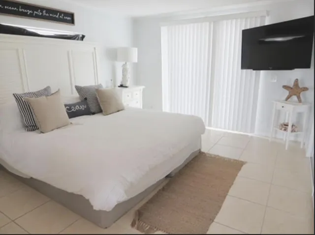 a large white bed in a white room