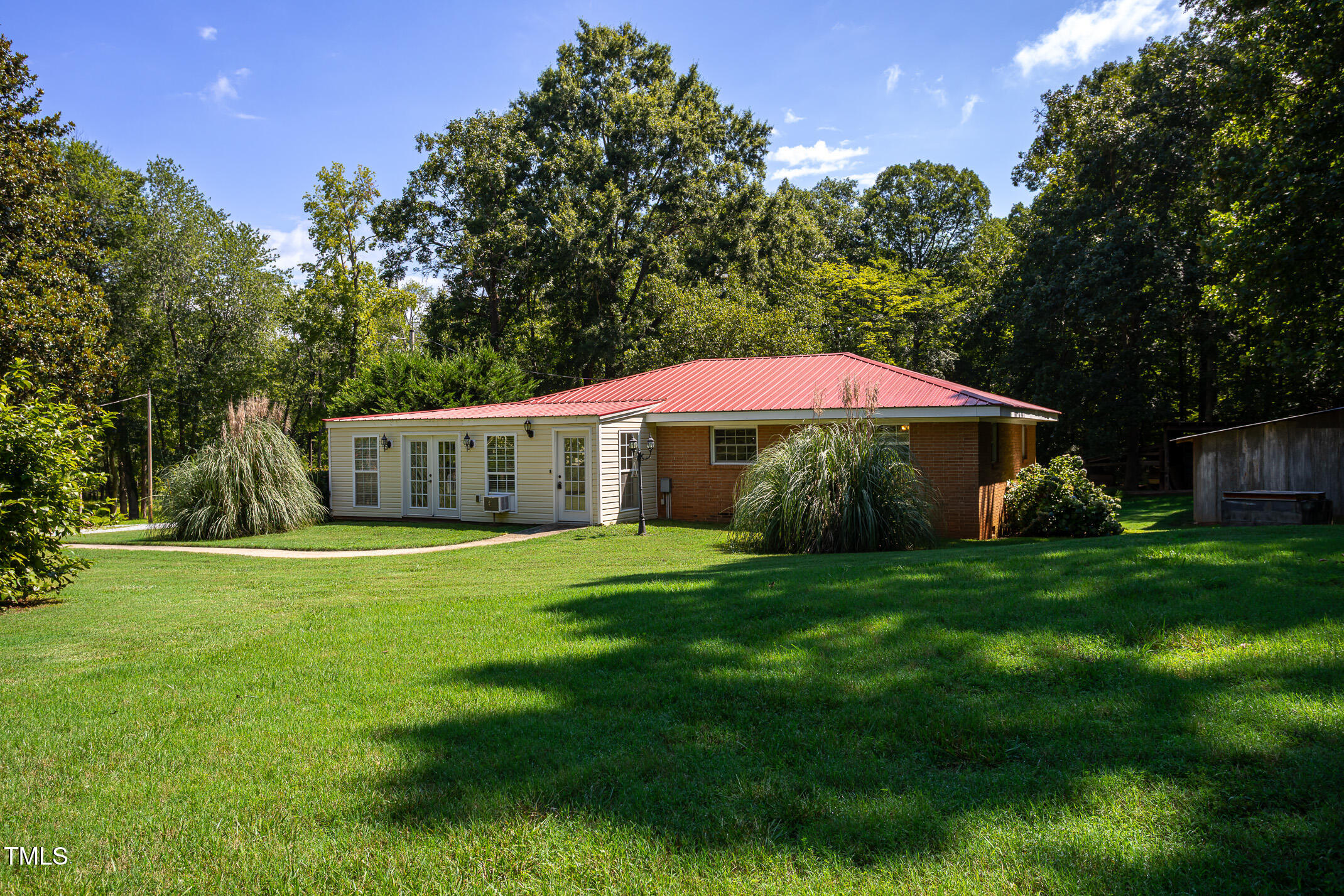 a backyard of a house with table and chairs