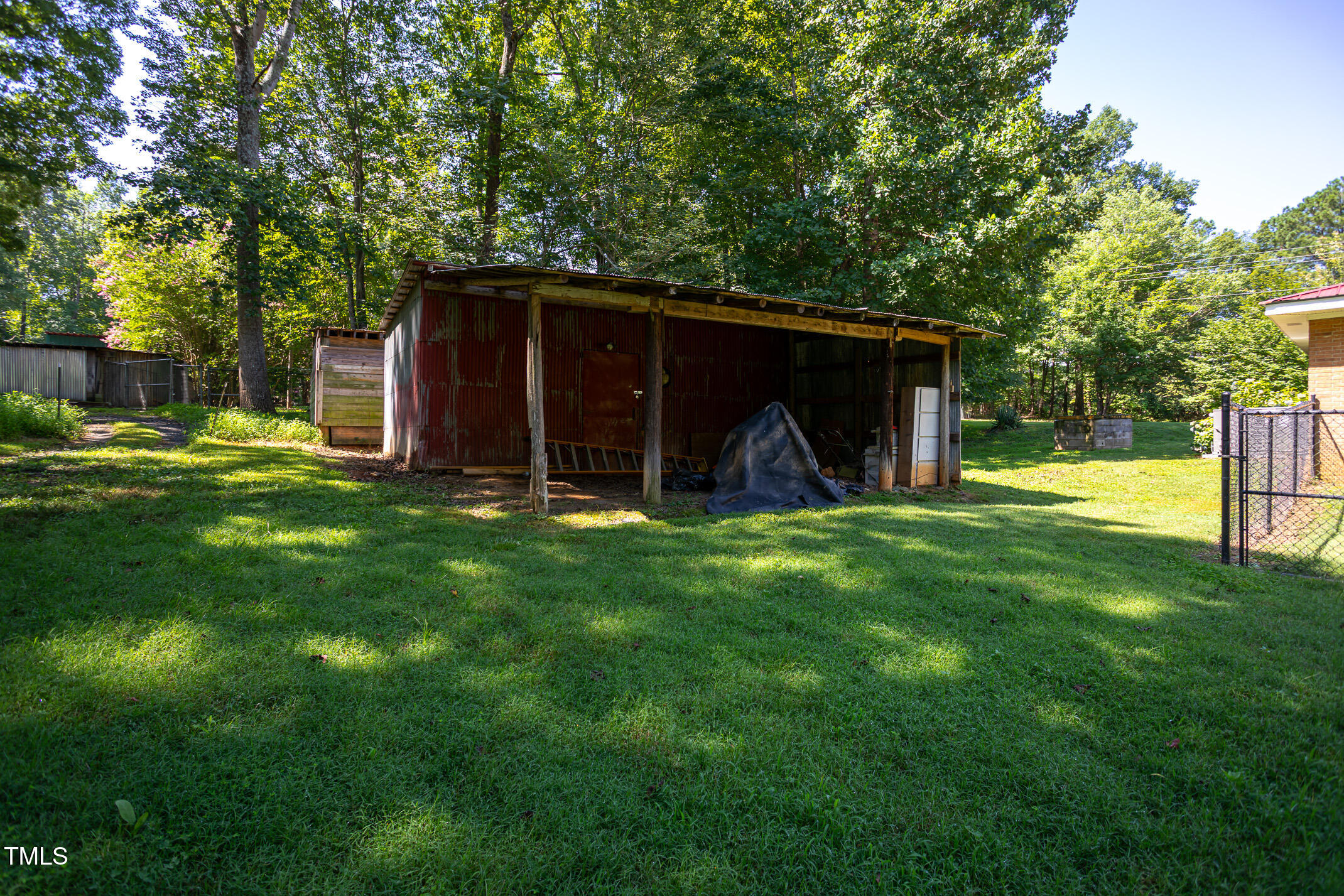 3622 Chestnut Ridge Church Road Efland, NC 27243 - Photo 21 of 22 a view of a back yard of the house with a large tree